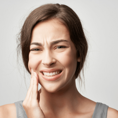 Woman holding jowl dealing with dental problem
