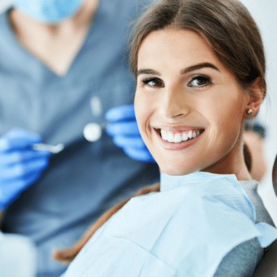 Reveal your smile’s true beauty with cosmetic dentistry 2 Woman smiling at the dentist, representing cosmetic dentistry