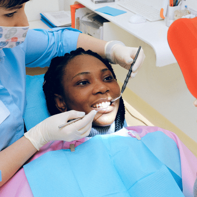 The benefits of professional fluoride treatment 2 Woman receiving dental treatment and care, representing the benefits of professional fluoride treatment